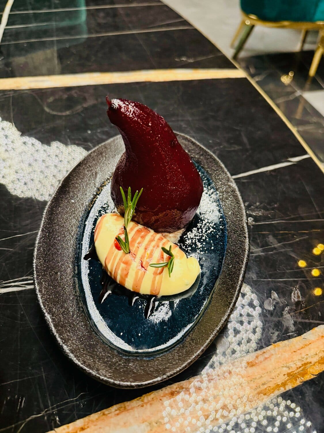 A plated seasonal dessert at Black Pearl on a dark marble table